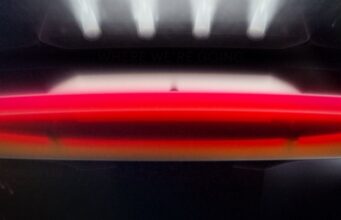 Tesla's official 'Go for launch' reveal graphic showing the red second-generation Roadster under vertical launch-pad lighting with the date 10.01