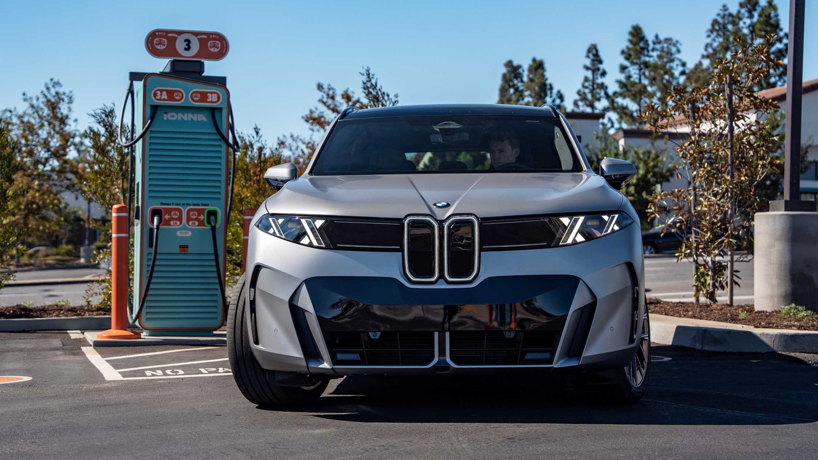 2027 BMW iX5 60 xDrive parked at an IONNA high-power charging stall in Southern California during a 460 kW DC charging demonstration