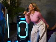 JBL PartyBox Ultimate 2 lighting a karaoke session with blue floor projection