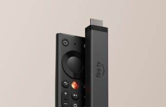 Fire TV Stick 4K Costs $59.99, but Prime Big Deal Days Cuts It to $29.99 Fire TV Stick 4K standing next to the new Fire TV Remote against a beige background