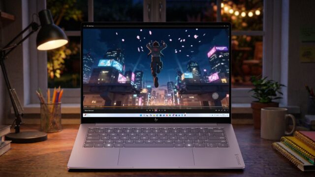 hp-omnibook-5-oled-lifestyle HP OmniBook 5 OLED laptop on a desk at night showing an animated city scene on its screen