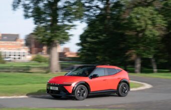 Hyundai Ioniq 3 Goes On Sale in the UK With EV Grant Red Hyundai IONIQ 3 electric hatchback driving on a UK road