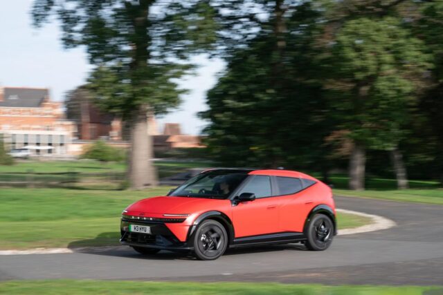 Red Hyundai IONIQ 3 electric hatchback driving on a UK road