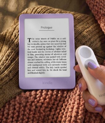 New Kindle Lineup Starts at $149.99, Paperwhite and Colorsoft Ship October 28 New 6-inch Kindle in Ube purple on a knit blanket next to a hand holding the Kindle Click page-turn remote