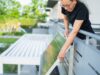 California Plug-In Solar Law Skips Utility Approval, but Caps Systems at 1,200 Watts Woman attaching a plug-in solar panel to the outside of a balcony railing