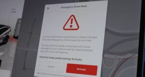 Tesla Emergency Drive Away Lets You Leave a Supercharger Plugged In, but Damage Can Reach $25,000 Tesla Emergency Drive Away dialog with a warning triangle, instructions to hold the brake and tap Activate, and a note about camera recordings