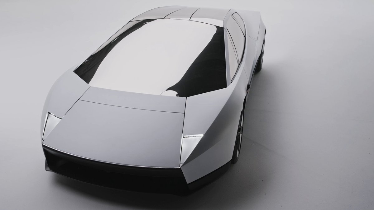 Top-three-quarter studio view of the redesigned silver Tesla Roadster showing its angular hood and F-35 and SR-71 inspired bodywork