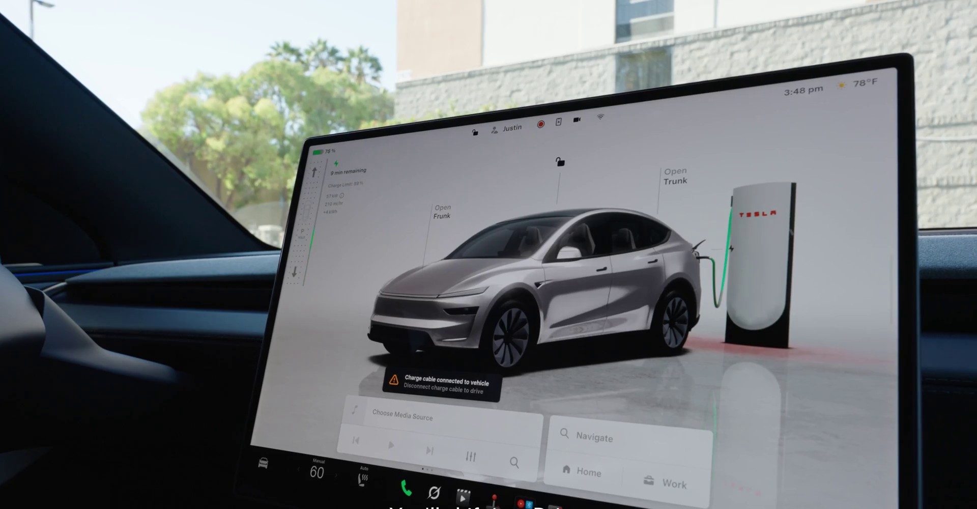 Tesla touchscreen showing a Model Y connected to a Supercharger with a cable warning on screen