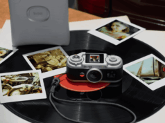 Instax Pal 2 App Bug Shrinks 10 MP USB-C No Frame Saves Instax Pal 2 camera on a vinyl record beside instant prints and a separate printer