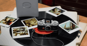 Instax Pal 2 App Bug Shrinks 10 MP USB-C No Frame Saves Instax Pal 2 camera on a vinyl record beside instant prints and a separate printer