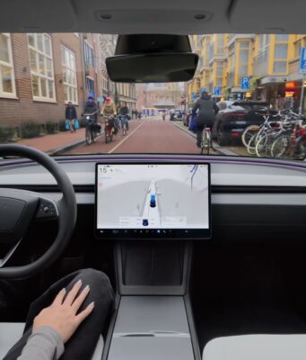 Tesla Assisted Driving Replaces Full Self-Driving In Europe Tesla Assisted Driving interior view from a driver seat on a Dutch city street, from Tesla Netherlands