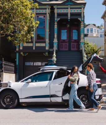 California Robotaxi Law Sets $10,000 Fines for Blocking First Responders, Starting in 2028 White Waymo Jaguar I-PACE robotaxi parked on a San Francisco street with riders loading the trunk